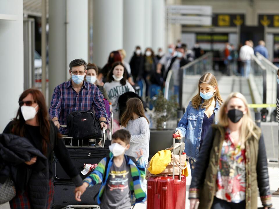 Passengers wearing protective face masks arrive at Son Sant Joan airport in Palma de Mallorca, ahead of Easter celebrations, Spain, April 1, 2021. REUTERS/Enrique Calvo