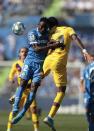 Getafe's Djene Dakonam, left, and Barcelona's Junior Firpo jump for the ball during the Spanish La Liga soccer match between Getafe CF and FC Barcelona in Getafe, outskirts of Madrid, Spain, Saturday, Sept. 28, 2019. (AP Photo/Bernat Armangue)