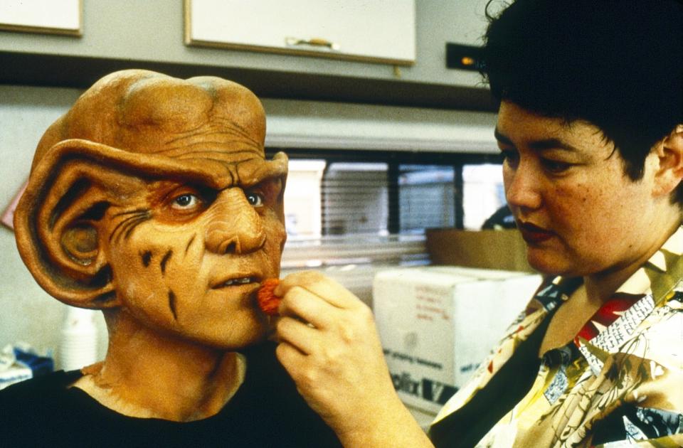 Makeup artist Karen Westerfield applies the prosthetics to turn Armin Shimerman into the Ferengi character Quark - Credit: ©Paramount/Courtesy Everett Collection