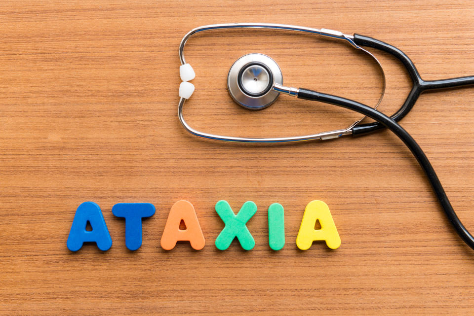 ataxia colorful word on the wooden background