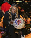 <p>The rapper helped the NBA celebrate its landmark 75th season by posing with a special crystal-covered ball.</p>