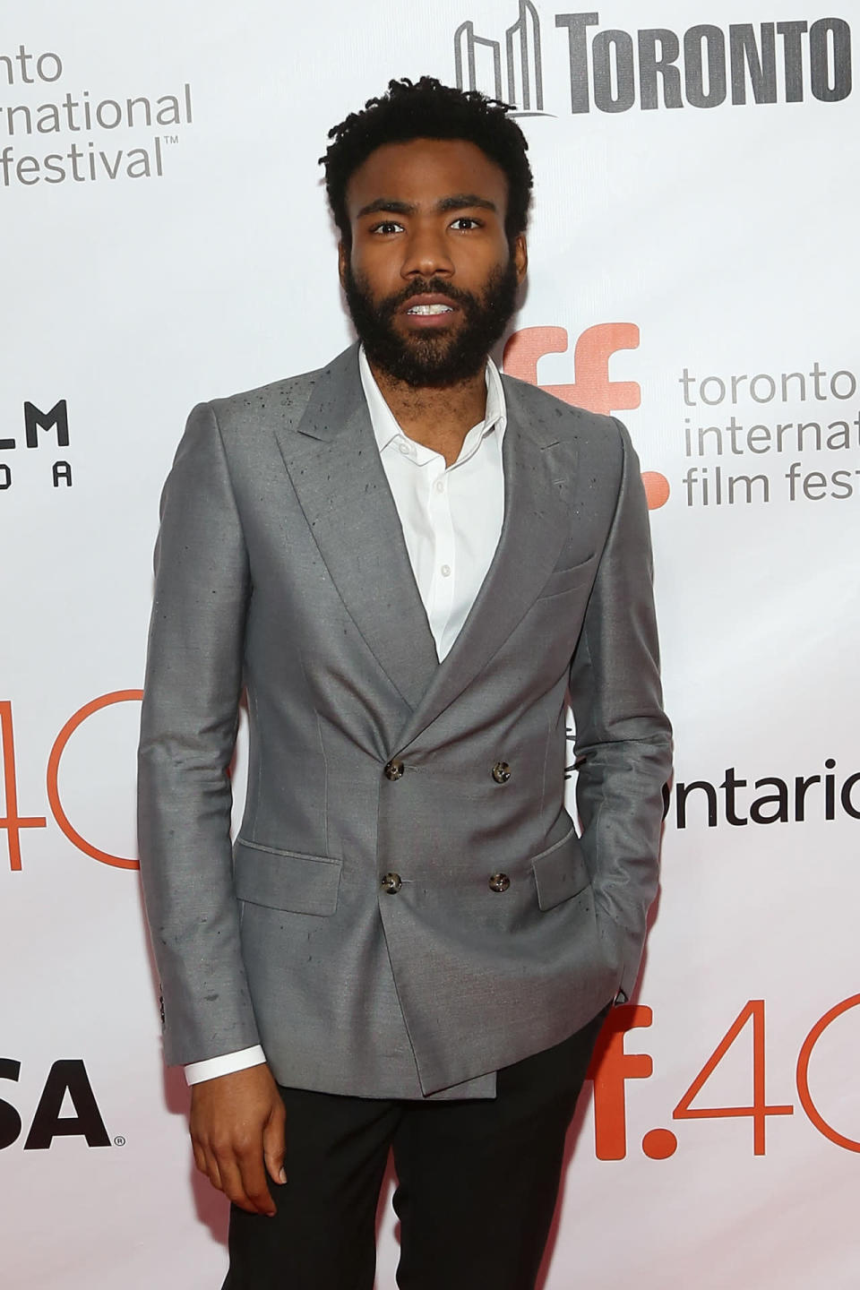 Donald Glover in a double breasted gray suit at ‘The Martian’ premiere during the 2015 Toronto International Film Festival at Roy Thomson Hall. 