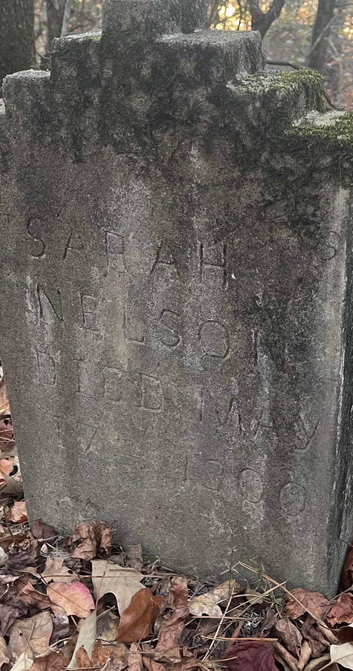 A tombstone sits in a forgotten cemetery on Marion road.