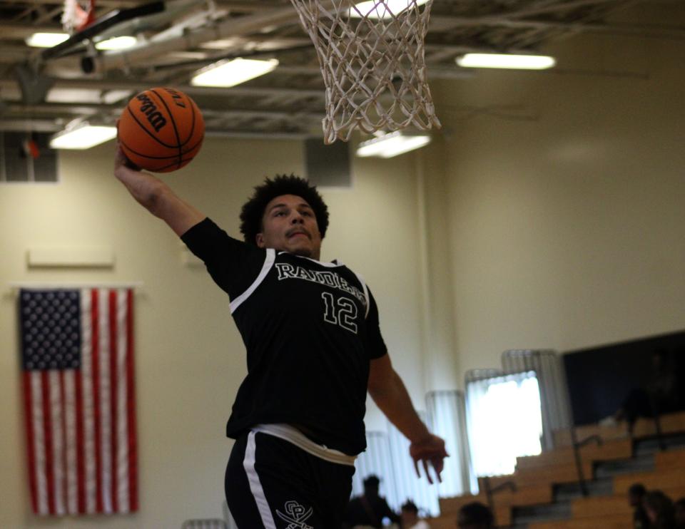 Orange Park guard Josiah Sabino (12) goes up for a dunk during a slam dunk contest before the Northeast Florida All-Star Classic.