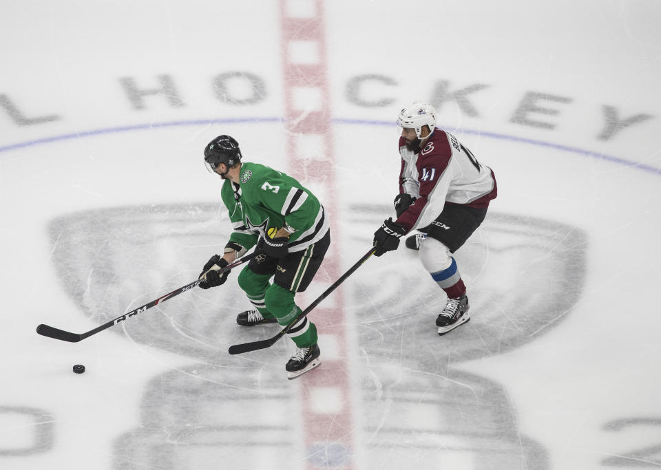 Dallas Stars' John Klingberg (3) is chased by Colorado Avalanche right wing Pierre-Edouard Bellemare (41) during the third period of Game 3 of an NHL hockey second-round playoff series, Wednesday, Aug. 26, 2020, in Edmonton, Alberta. (Jason Franson/The Canadian Press via AP)