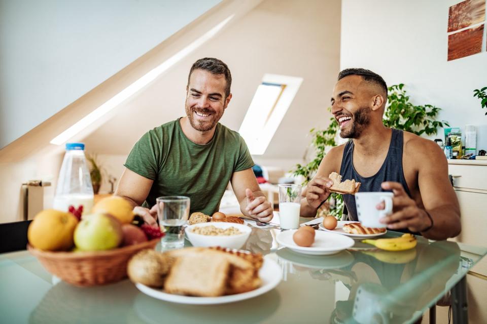 gay couple having breakfast at home