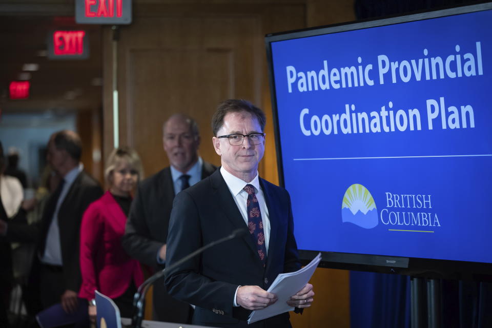 Health Minister Adrian Dix, front, British Columbia Premier John Horgan and provincial health officer Dr. Bonnie Henry arrive for a news conference about the provincial response to the coronavirus, in Vancouver, Canada, on Friday, March 6, 2020. (Darryl Dyck/The Canadian Press via AP)