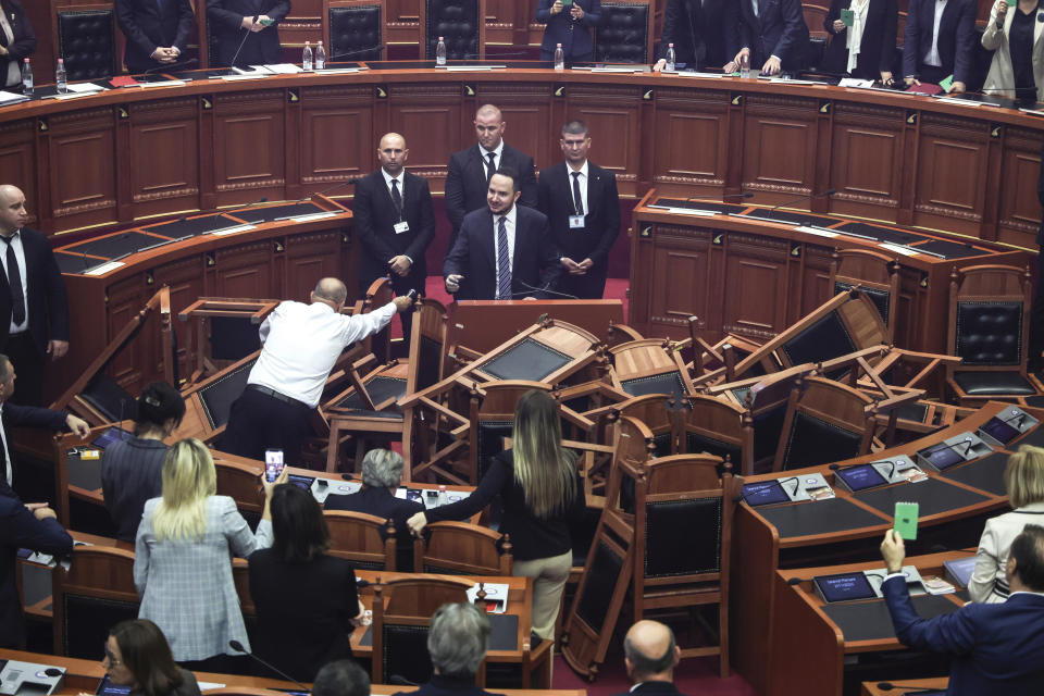 Chairs thrown by opposition lawmakers are seen during a parliament session in Tirana, Albania, Thursday, Nov. 2, 2023. Albanian opposition has tried to disrupt the parliamentary session in protest to what they called the authoritarian rule from the governing Socialist party. (AP Photo)