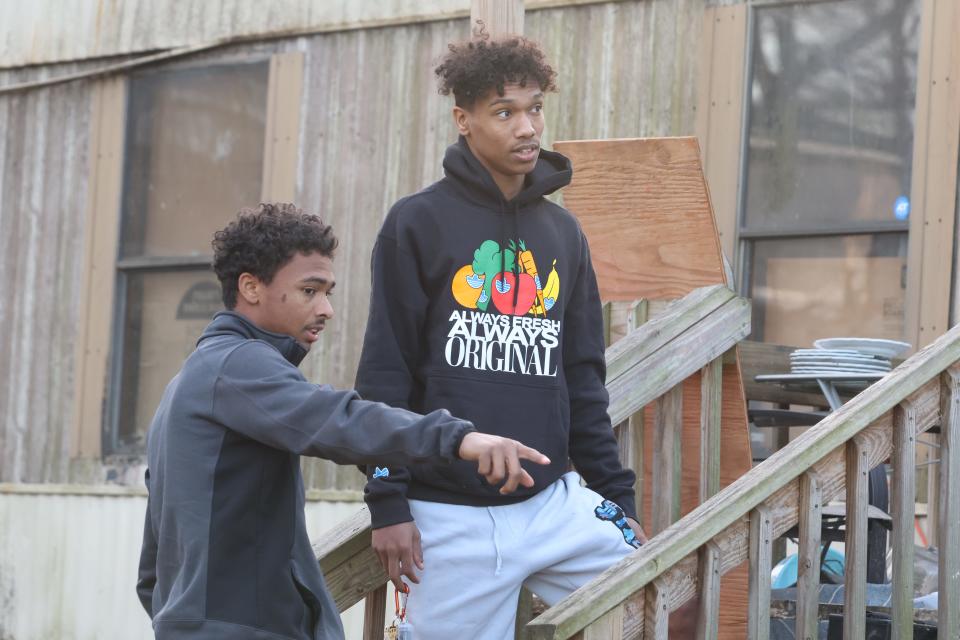 Eric Ware (left) and brother Isaiah survey damage of the home they share with their grandmother in Clarksville, Tenn. on Dec. 13, 2023.