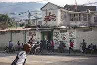 This photo provided by Doctors Without Borders shows locals standing outside its emergency clinic in the Martissant neighborhood of Port-au-Prince, Haiti, Sunday, Dec. 2, 2020. Officials said Monday, August 2, 2021, that Doctors Without Borders has closed the Martissant emergency clinic in Haiti's capital amid gang violence that has left more than 19,000 people homeless. (Guillaume Binet/Doctors Without Borders via AP)