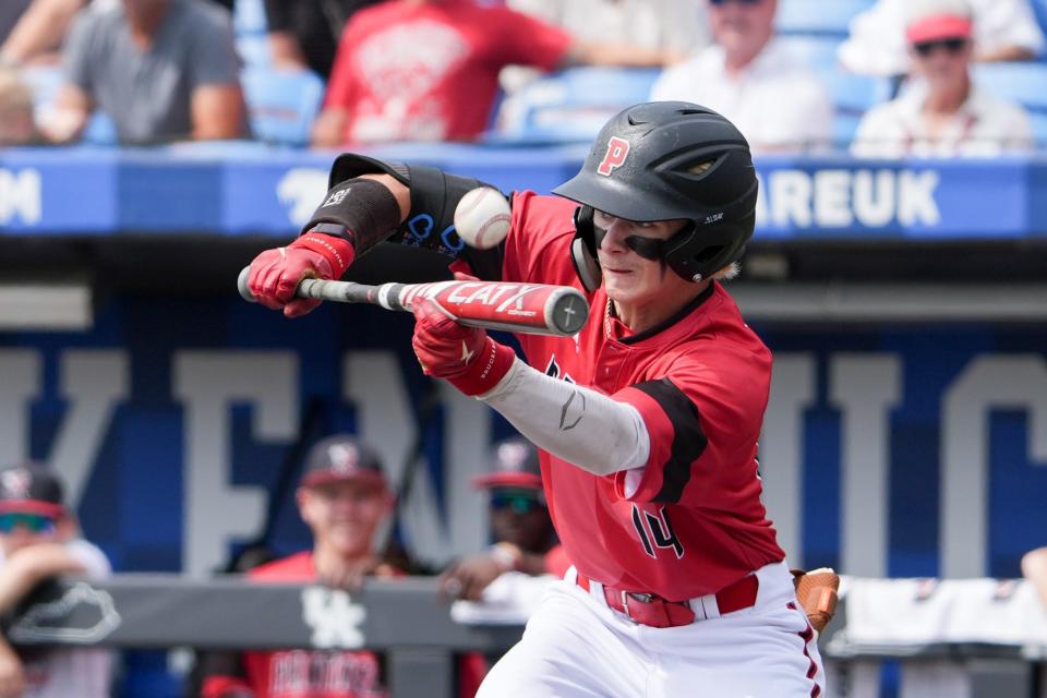 Pleasure Ridge Park's Brayden Bruner (14) bunts during their game against Trinity on Friday, June 14, 2024 in Lexington, Ky. at Kentucky Proud Park for the state baseball semifinals.