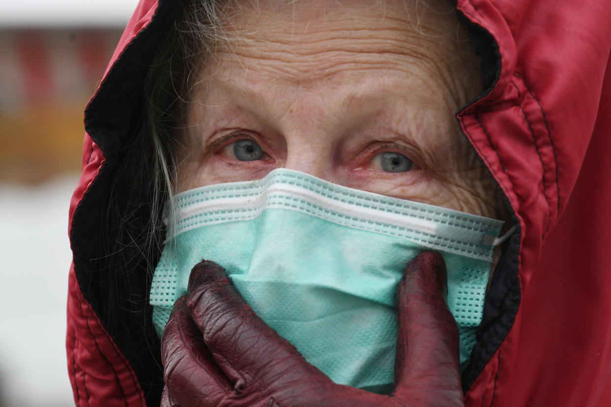 A woman wearing a protective face mask and gloves shops on a market, in Illiers-Combray, on April 3, 2020, amid the spread of the epidemic COVID-19 caused by the novel coronavirus. - France has been on lockdown since March 17 in a bid to limit the contagion caused by the novel coronavirus, a situation it has extended until a least April 15. (Photo by Jean-Francois MONIER / AFP) (Photo by JEAN-FRANCOIS MONIER/AFP via Getty Images)