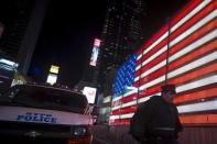 A New York police officer walks from a van that was deployed in Times Square to bolster security after the attacks in Paris, in the Manhattan borough of New York November 13, 2015. REUTERS/Carlo Allegri