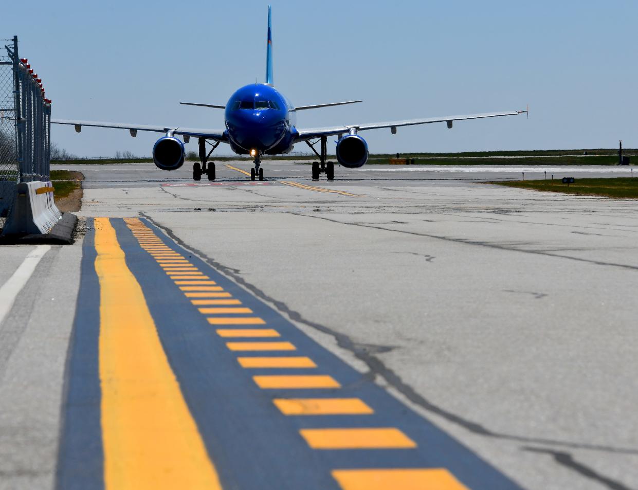 A JetBlue jet taxis on the runway after landing at Worcester Regional Airport.