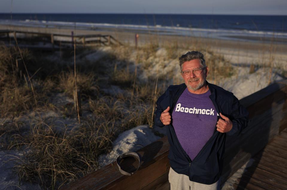 Kevin Brown shows off his "Beachneck" shirt. He often gives a shirt like that to volunteers in his beach-protection efforts.