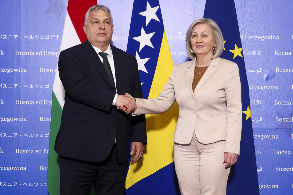 Hungarian Prime Minister Viktor Orban, left, shakes hands with the President of the Council of Ministers of Bosnia and Herzegovina Borjana Kristo prior to their meeting in Sarajevo, Bosnia, Thursday, April 4, 2024. (AP Photo)