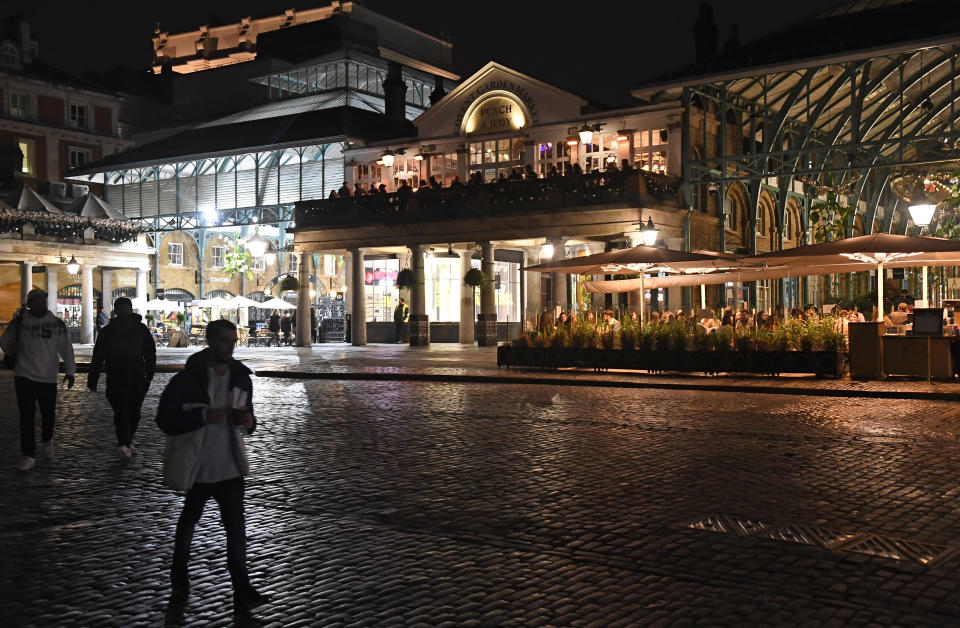 A view across a sparsely crowded Covent Garden in central London, Saturday, Oct. 31, 2020. Earlier Saturday British Prime Minister Boris Johnson announced England will start a monthlong lockdown next week. Johnson says the new measures will begin Thursday and last until Dec. 2. (AP Photo/Alberto Pezzali, Pool)