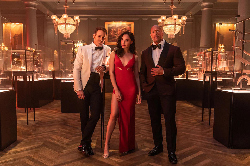 Still Red Notice where Ryan Reynolds, Gal Gadot and Dwayne Johnson pose in glamorous evening wear 