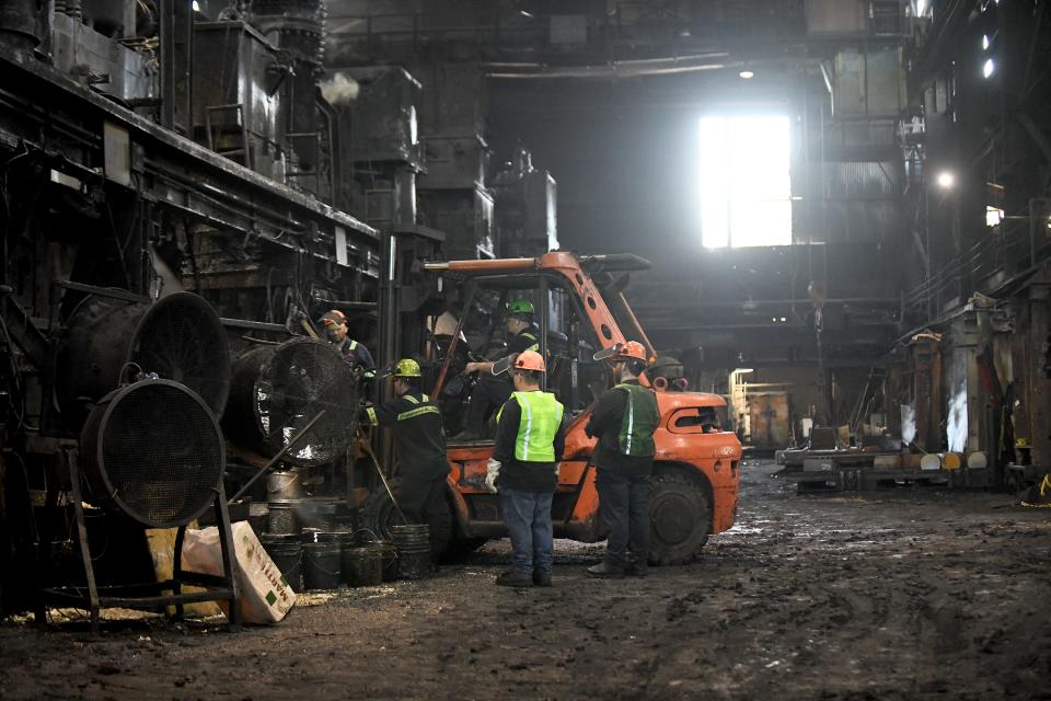 Workers at the Canton Drop Forge factory in Perry Township prepare a hammer to forge steel parts. The company is adding equipment and employees.