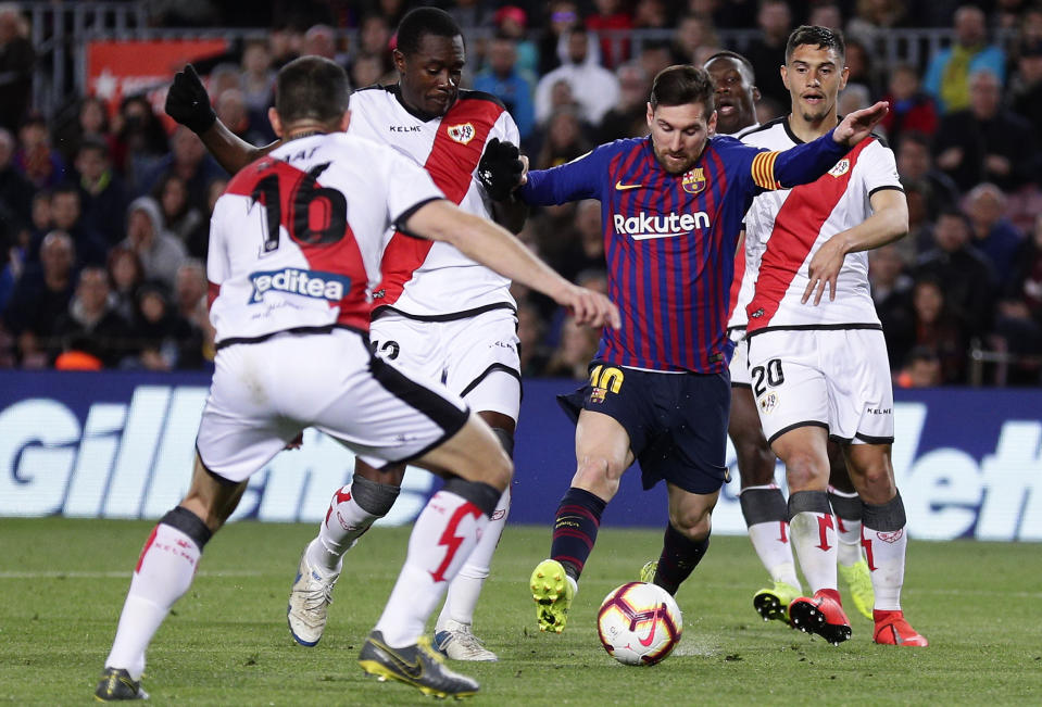 FC Barcelona's Lionel Messi, second right, duels for the ball during the Spanish La Liga soccer match between FC Barcelona and Rayo Vallecano at the Camp Nou stadium in Barcelona, Spain, Saturday, March 9, 2019. (AP Photo/Manu Fernandez)