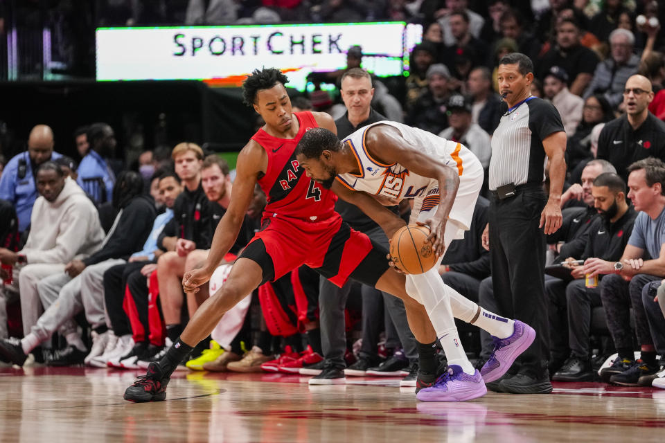 TORONTO, ON - NOVEMBER 29: Scottie Barnes #4 of the Toronto Raptors defends against Kevin Durant #35 of the Phoenix Suns during second half action at the Scotiabank Arena on November 29, 2023 in Toronto, Ontario, Canada. NOTE TO USER: User expressly acknowledges and agrees that, by downloading and/or using this Photograph, user is consenting to the terms and conditions of the Getty Images License Agreement. (Photo by Andrew Lahodynskyj/Getty Images)