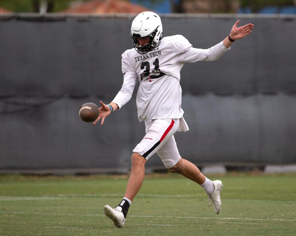 Texas Tech's Austin McNamara punts the ball during practice, Tuesday, April 19, 2022, at the Football Training Facility.