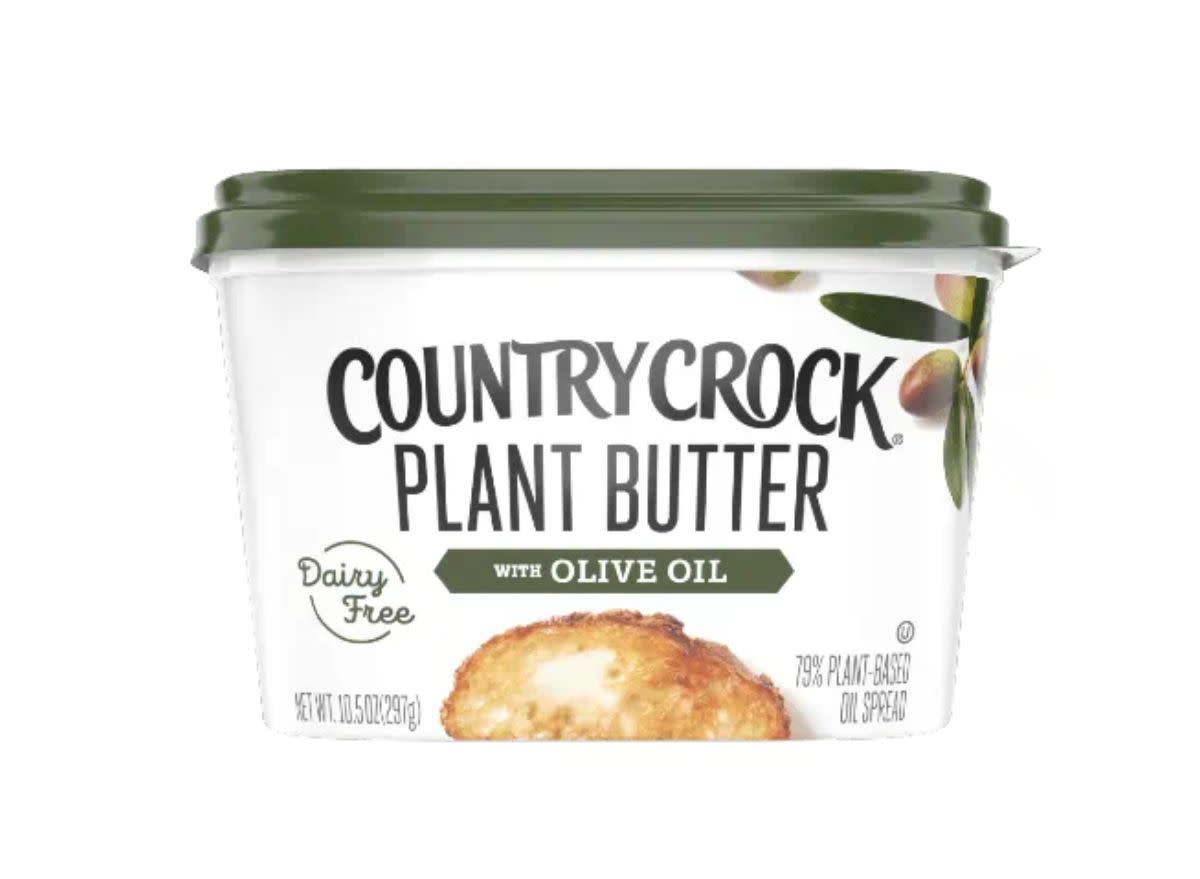 container of butter substitute on a white background