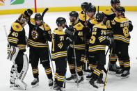 Boston Bruins Tuukka Rask (40) and teammates celebrate after defeating the Washington Capitals during an NHL hockey game, Sunday, April 18, 2021, in Boston. (AP Photo/Michael Dwyer)