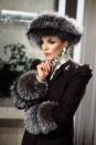 <p>The queen of snark defined '80s glamour with a wardrobe full of fur, ruffles, lamé, and shoulder pads. A <em>lot</em> of shoulder pads.</p>