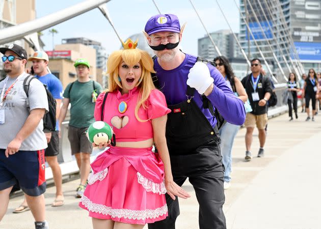 Cosplayers dressed as Princess Peach and Waluigi from 