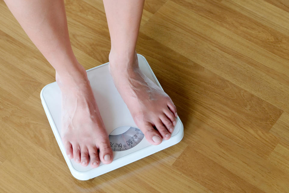 Legs of men standing on scales weight. Concept of health and weight loss.
