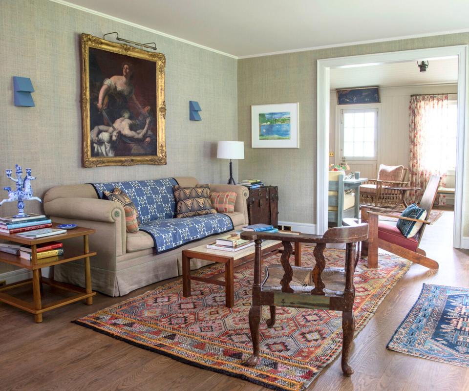 living room with cream sofa and painting in gilt frame