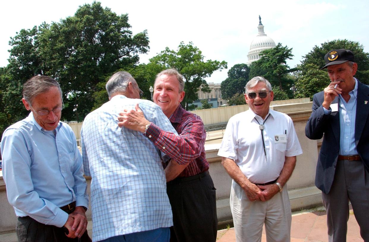 Edward Shames, center, hugs Ed McClung, a fellow veteran of Army Company E of the 506th Regiment of the 101st Airborne, at a 2003 event in Washington, D.C. They are joined by fellow World War II veterans Jack Foley, left, and Joe Lesniewski and Shifty Powers, right and far right.