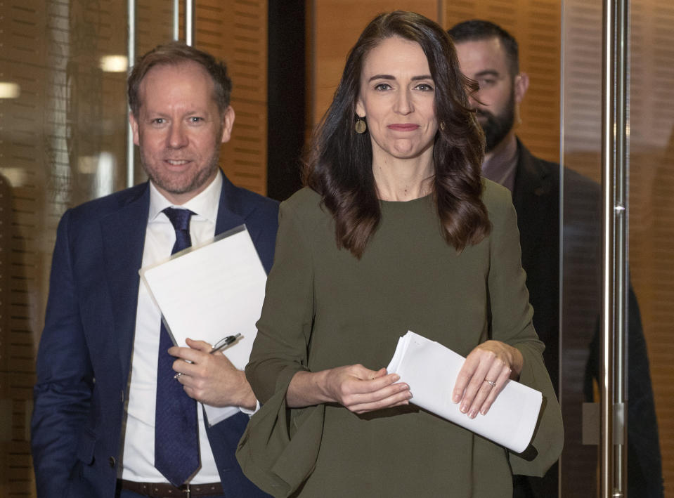 New Zealand Prime Minister Jacinda Ardern, center, arrives to announce a new date for national elections, at a news conference in Wellington, New Zealand, Monday, Aug. 17, 2020. The election had been scheduled for Sept. 19 but will now be held on Oct. 17, after a COVID-19 outbreak in Auckland. (Mark Mitchell/New Zealand Herald via AP)