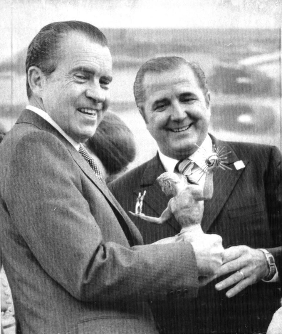 On Sept. 23, 1971, President Richard Nixon is presented a replica of the "Spirit of Detroit" statue by Detroit Mayor Roman Gribbs, as the president arrived in Detroit to address the Detroit Economic Club.