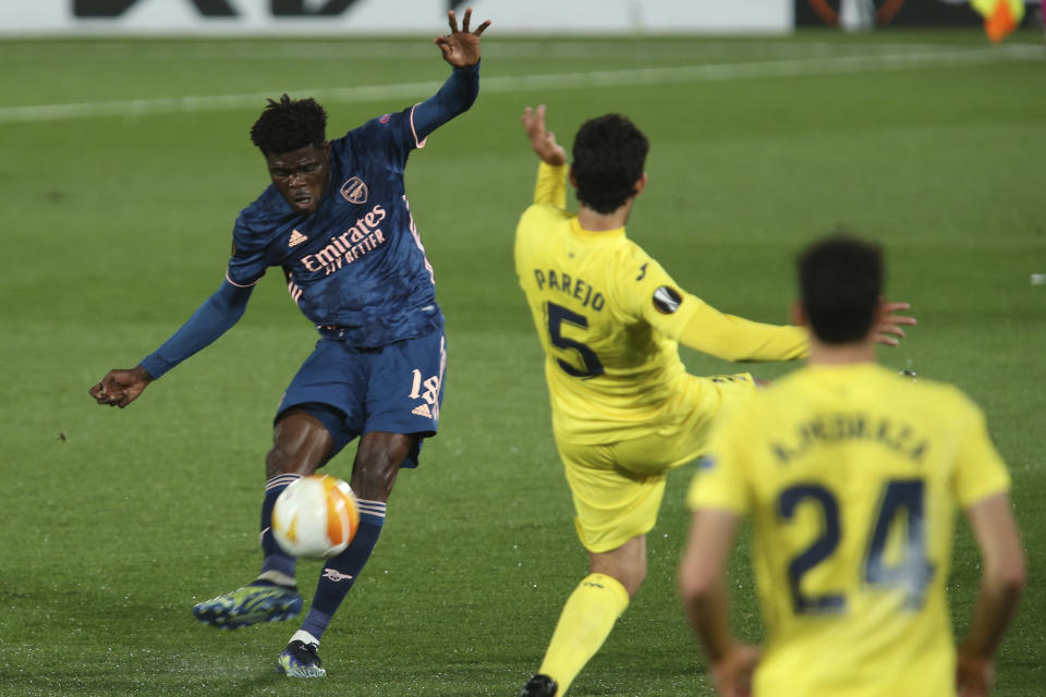 Arsenal's Thomas Partey, left, in action during the Europa League semifinal first leg soccer match between Villarreal and Arsenal at the Estadio de la Ceramica stadium in Villarreal, Spain, Thursday, April 29, 2021. (AP Photo/Alberto Saiz)