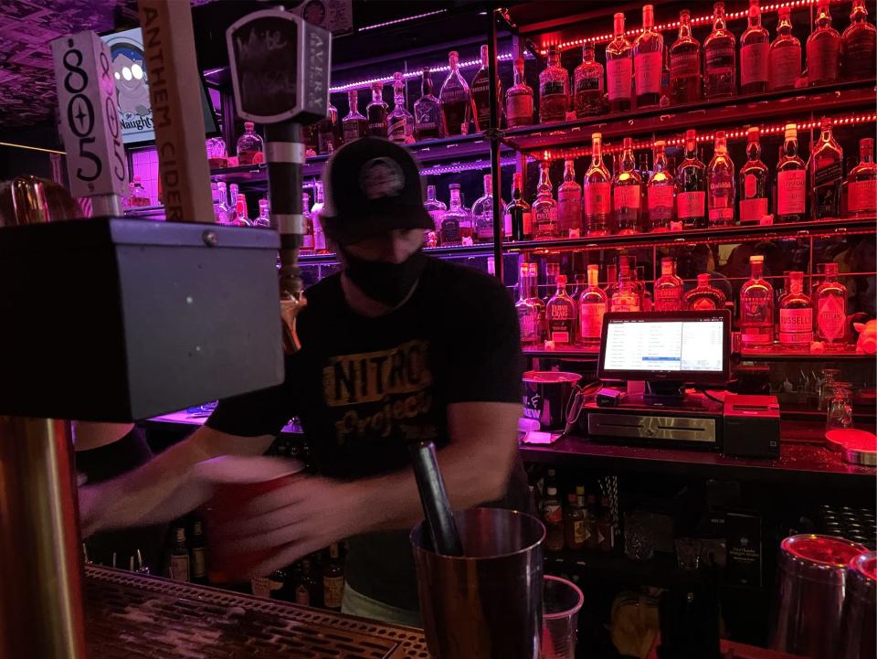 A bartender at The Naughty Pig filled red Solo cups with mixed drinks for Spears fans.