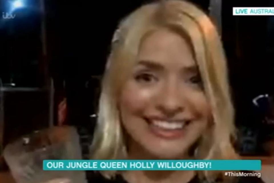 Party mode: Holly Willoughby had her drink in hand as she called Phillip Schofield (ITV)