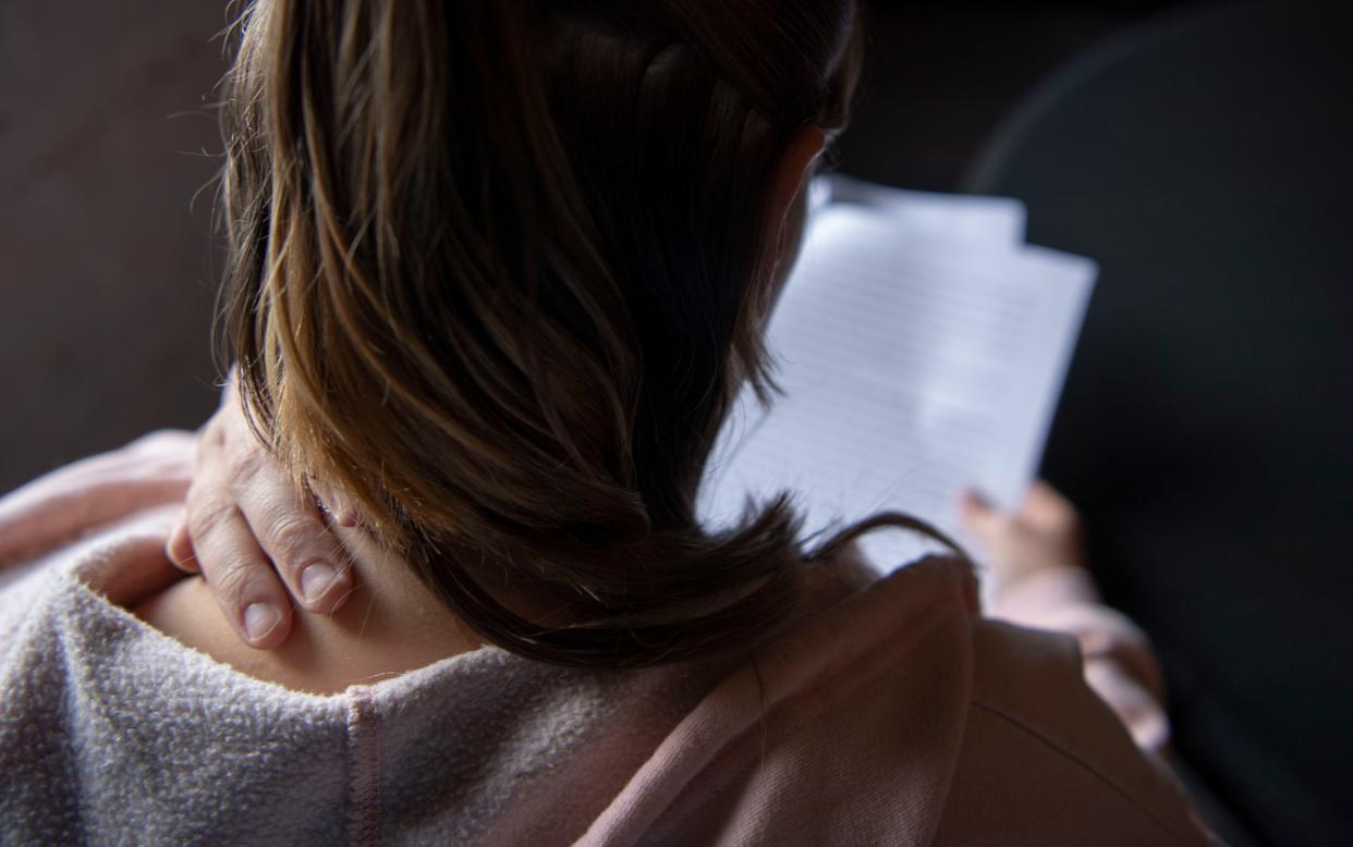 A woman reads her lawsuit filed in federal court challenging portions of Tennessee's sexual offender registry statutes at her attorney's office in Nashville, Tenn., on Wednesday, Oct. 18, 2023.