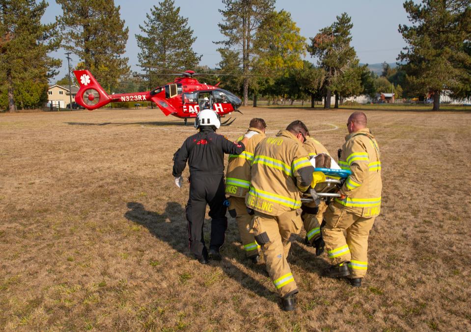 First responders take a student "victim" on a stretcher toward a waiting helicopter during a mock accident demonstration as part of Every 15 Minutes on Tuesday, Oct. 18, 2022.