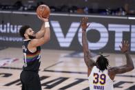 Denver Nuggets guard Jamal Murray, left, takes a shot over Los Angeles Lakers center Dwight Howard (39) during the second half of Game 3 of the NBA basketball Western Conference final Tuesday, Sept. 22, 2020, in Lake Buena Vista, Fla. (AP Photo/Mark J. Terrill)