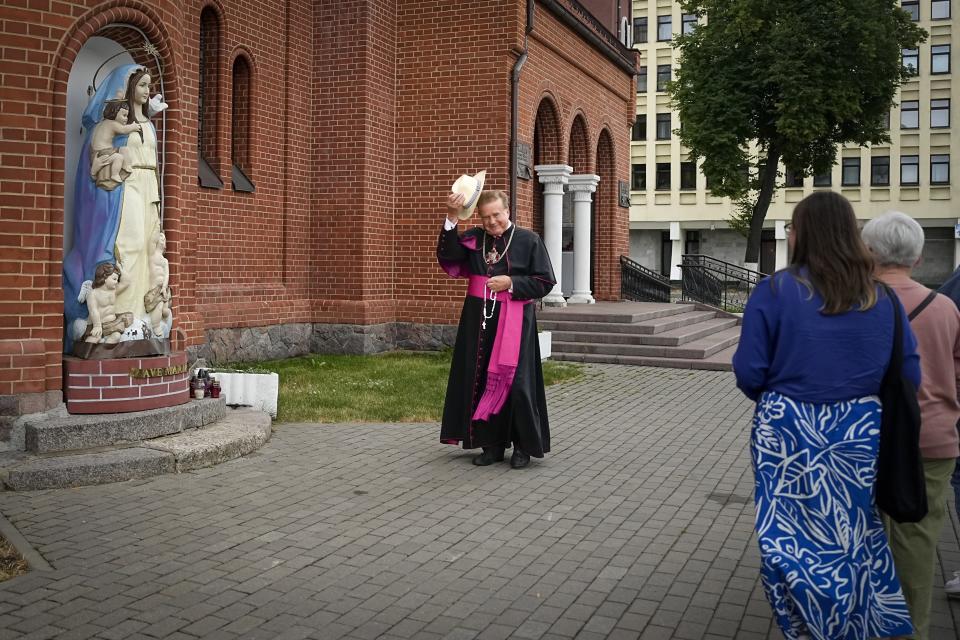 FILE – The Rev. Uladislau Zavalnyuk greets people as he walks around Sts. Simon and Helena Catholic Church in Minsk, Belarus, on Thursday, July 6, 2023. Amid anti-government demonstrations in 2020 against the election that gave Belarusian President Alexander Lukashenko a sixth term, about 100 people took refuge from police in the landmark “Red Church,” as it was known for the color of its bricks. Authorities later halted services at the church. (AP Photo, File)