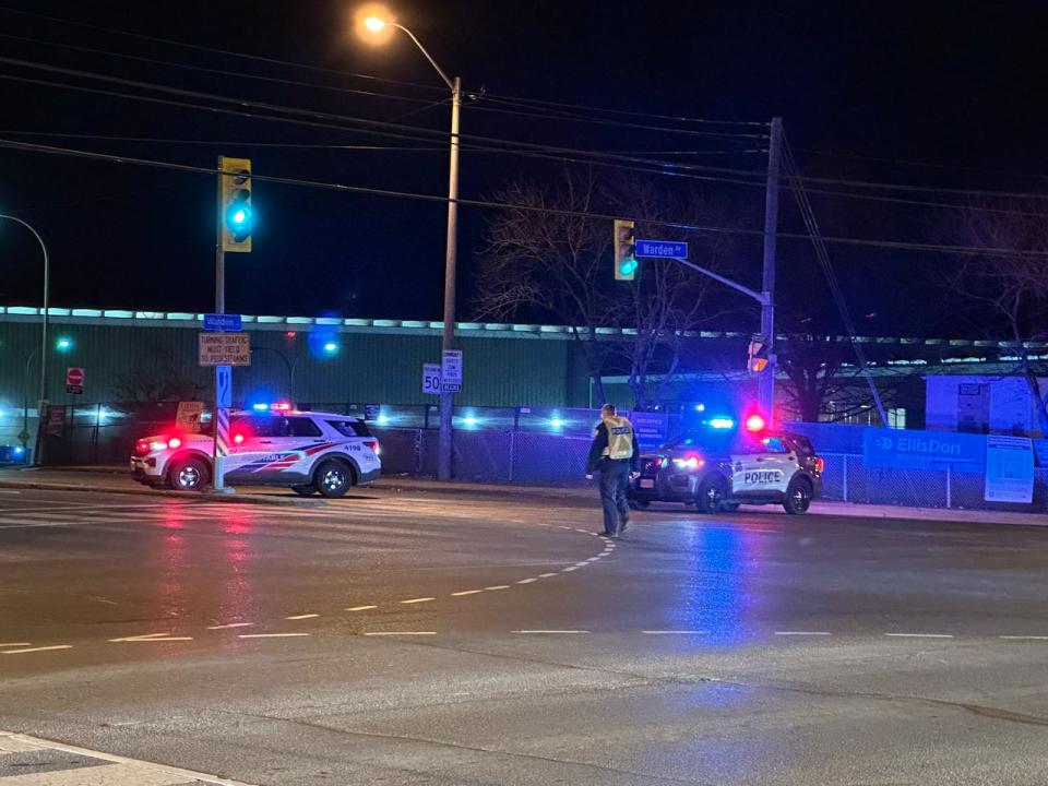 A Toronto police officer steps out of his vehicle to direct traffic briefly after the death of a cyclist in Scarborough prompted a road closure on Monday. The cyclist, a man, died in hospital after he was struck by a vehicle.