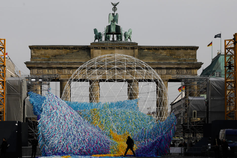 The skynet artwork 'Visions In Motion' is set to overhang the 'Strasse des 17. Juni' (Street of June 17) boulevard in front of the Brandenburg Gate in Berlin, Germany, Friday, Nov. 1, 2019. The art work by Patrick Shearn was made with about 100.000 streamers with written messages and is part of the celebrations marking the 30th anniversary of the fall of the Berlin Wall on Nov 9, 2019. (AP Photo/Markus Schreiber)