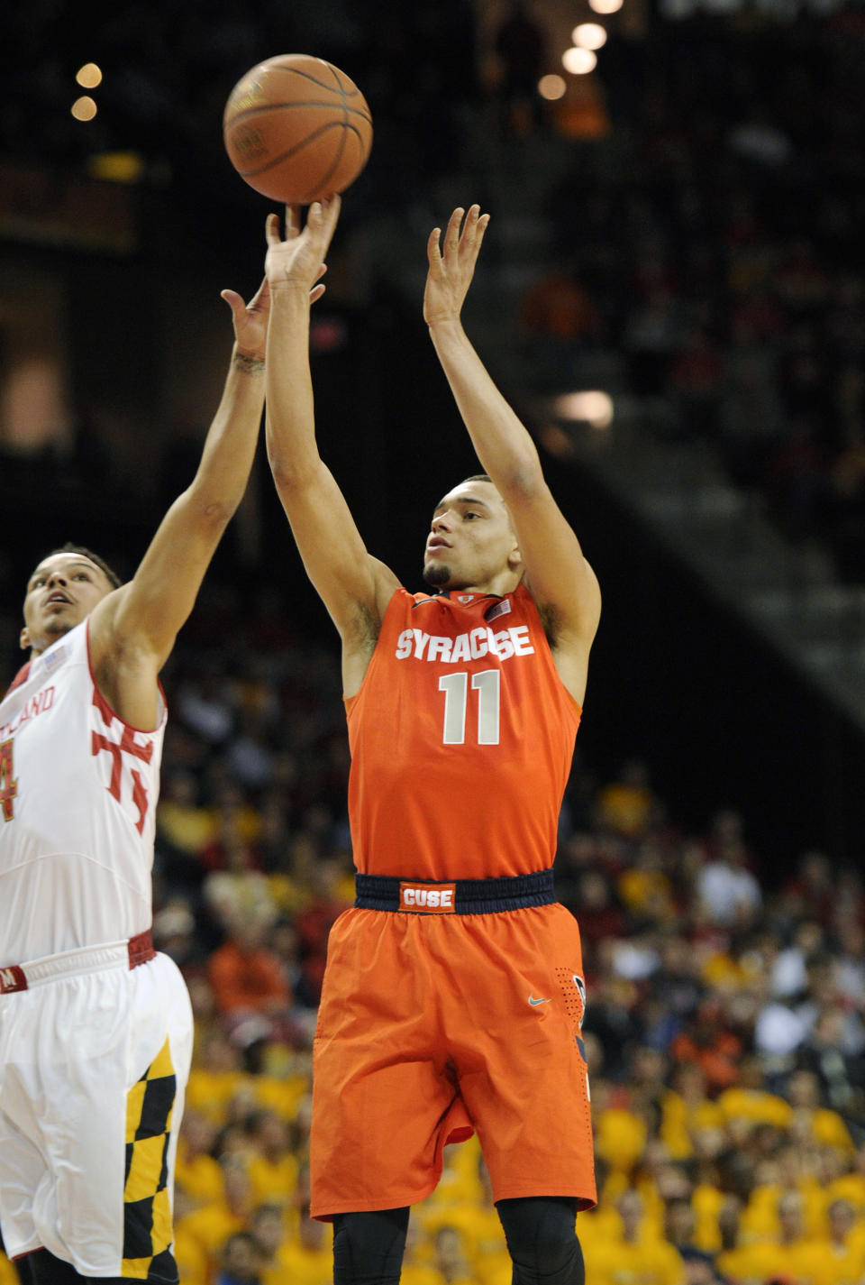 Syracuse guard Tyler Ennis (11) shoots against Maryland guard Seth Allen, left, during the first half of an NCAA college basketball game, Monday, Feb. 24, 2014, in College Park, Md. Syracuse won 57-55. (AP Photo/Nick Wass)