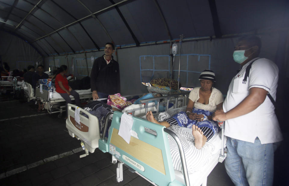 Patients are evacuated to a tent outside a hospital, following an earthquake in Bali, Indonesia, Monday, Aug. 6, 2018. A powerful earthquake struck the Indonesian tourist island of Lombok on Sunday, shaking neighboring Bali, one week after another quake on Lombok killed more than a dozen. (AP Photo/Firdia Lisnawati)