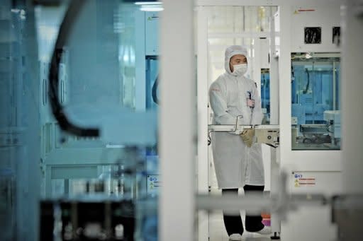 File photo of a worker making solar cells at a Trina Solar plant in Changzhou, China. Four leading firms in China warned Thursday that a possible EU anti-dumping investigation could trigger a trade war and urged Beijing to step in to protect their interests