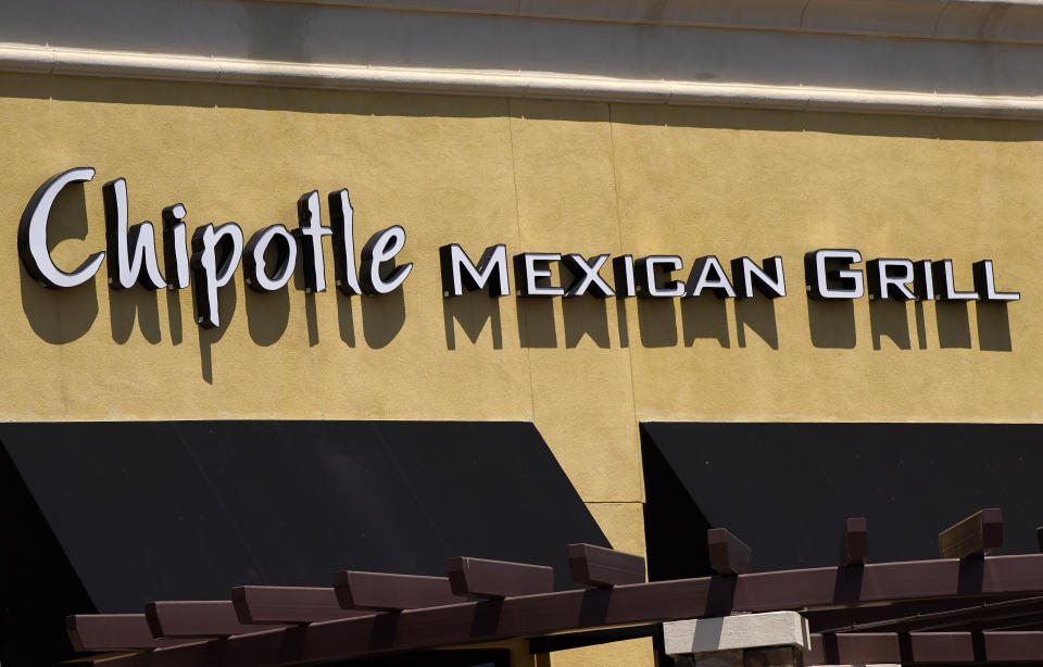 A Chipotle Mexican Grill restaurant is seen at the Simi Valley Town Center, Tuesday, April 21, 2020, in Simi Valley, Calif. Federal prosecutors say Chipotle Mexican Grill has agreed to pay a record $25 million fine to resolve criminal charges that it served tainted food that sickened more than 1,100 people in the U.S. from 2015 to 2018. The fast food company was charged Tuesday in Los Angeles federal court with two counts of violating the Food, Drug, and Cosmetic Act by serving adulterated food. The charges stem from outbreaks of norovirus, which causes diarrhea, at Chipotle restaurants. The virus is easily transmitted by infected food food workers. The Newport Beach, California-based company will avoid conviction by improving its food safety. (AP Photo/Mark J. Terrill)