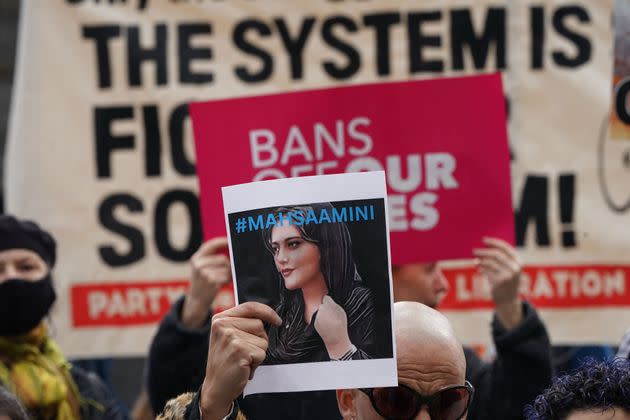 A demonstrator in New York City holds up a photo of Mahsa Amini in solidarity with protesters in Iran fighting for women's rights. The 22-year-old Amini was killed in the custody of Iran's religious police for improperly wearing her headscarf. Her death in mid-September has sparked weeks of heated protests. (Photo: BRYAN R. SMITH via Getty Images)