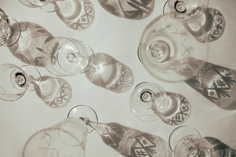 Various clear glassware casting intricate patterned shadows